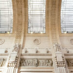Ornate carvings and glass skylights in the stone ceiling of Milan