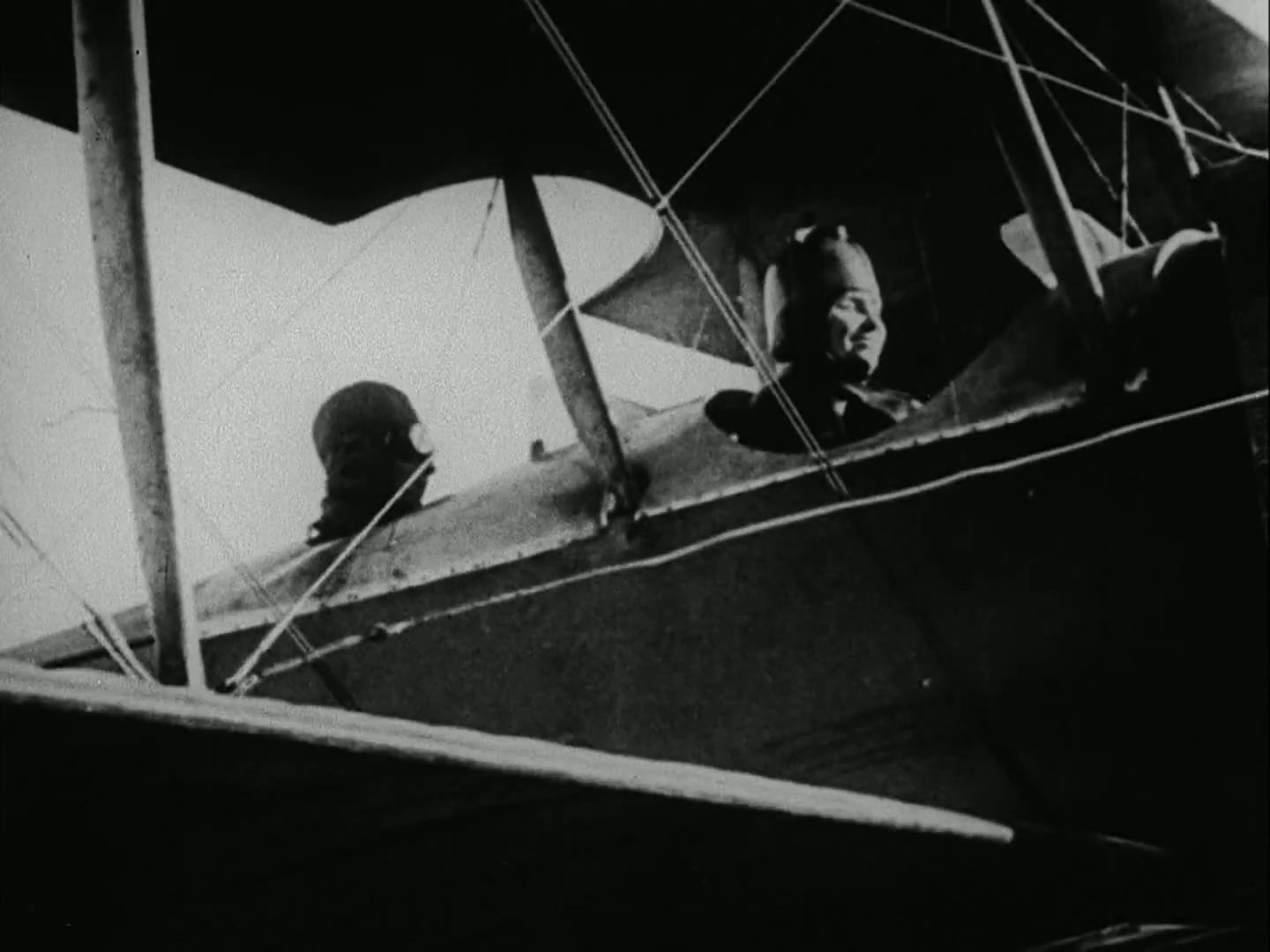 Helen Keller and Anne Sullivan in the cockpit of an airplane during the filming of "Deliverance," 1919, highlighting Keller's early aviation experience.