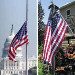 US flag on pole at half mast alongside residential mounted flag with black mourning streamer