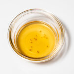 Home remedy for catching fruit flies and small insects with glass bowl of cider vinegar and drop of detergent