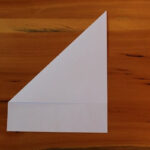 Step 1 — Fold top left corner down.
