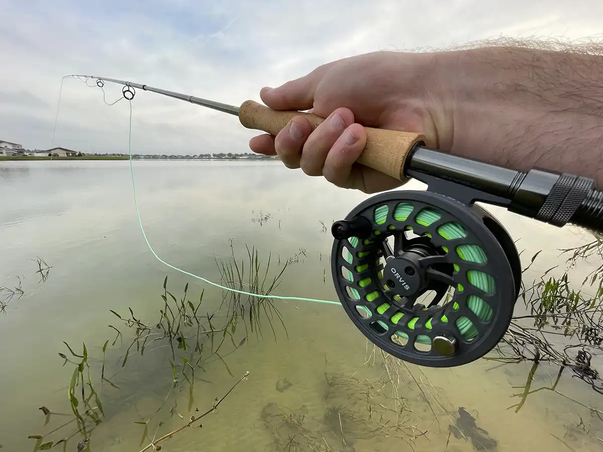 Fly fishing gear for largemouth bass, including a fly rod, reel, and fly box