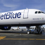 JetBlue airplane at John F. Kennedy International Airport, showcasing the airline's presence in major transportation hubs.