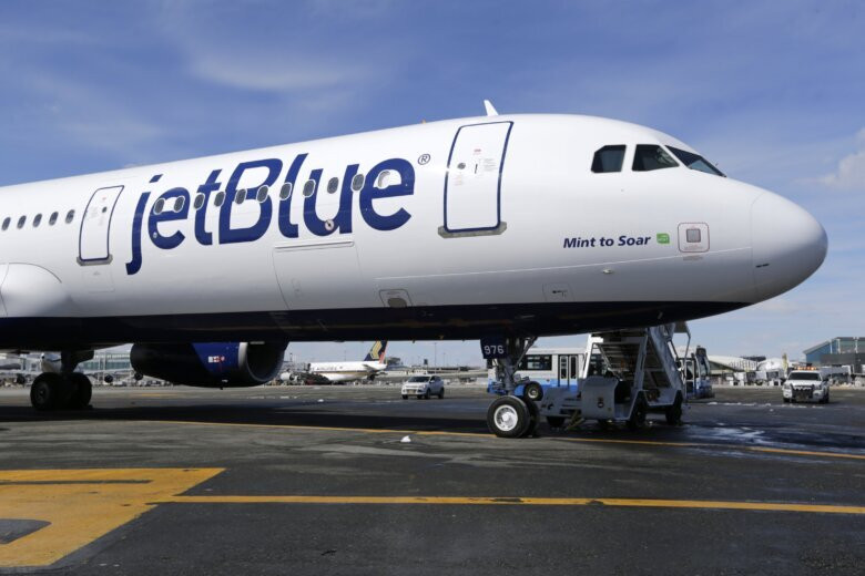 JetBlue airplane at John F. Kennedy International Airport, showcasing the airline's presence in major transportation hubs.