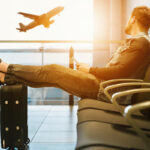 Man looking out of the window at an airport