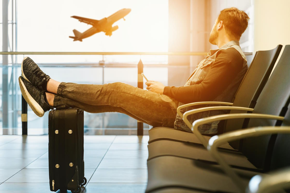 Man looking out of the window at an airport