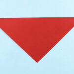 Square paper folded diagonally for origami dragon