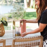 girl setting a brass lantern on a table