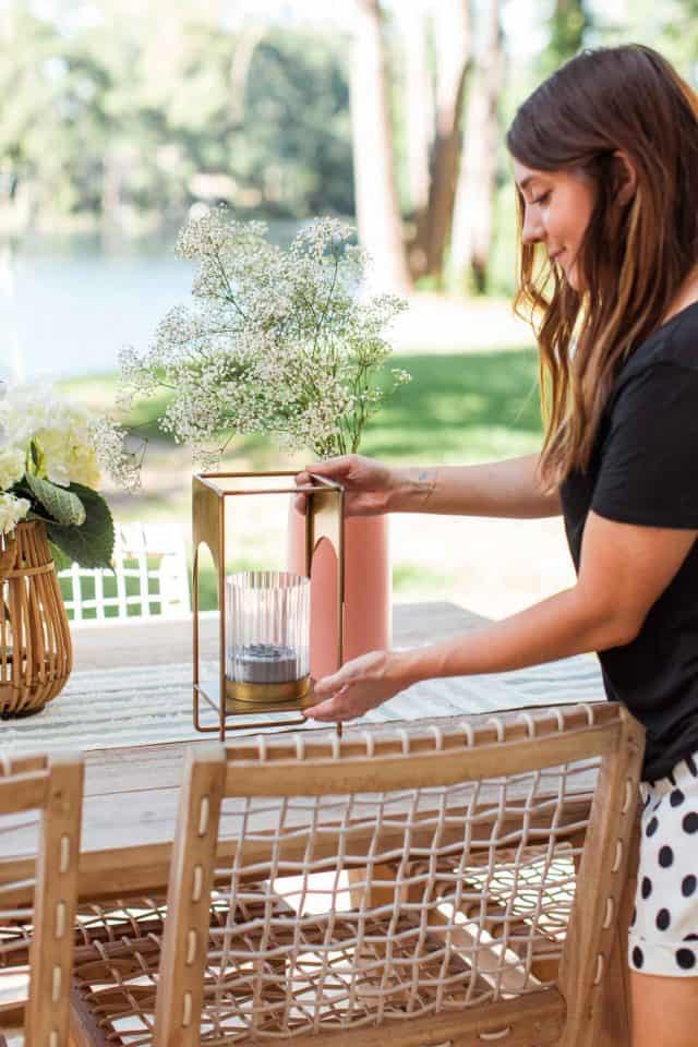 girl setting a brass lantern on a table