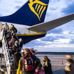 Passengers boarding a commercial airliner