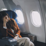Frustrated woman sitting on an airplane