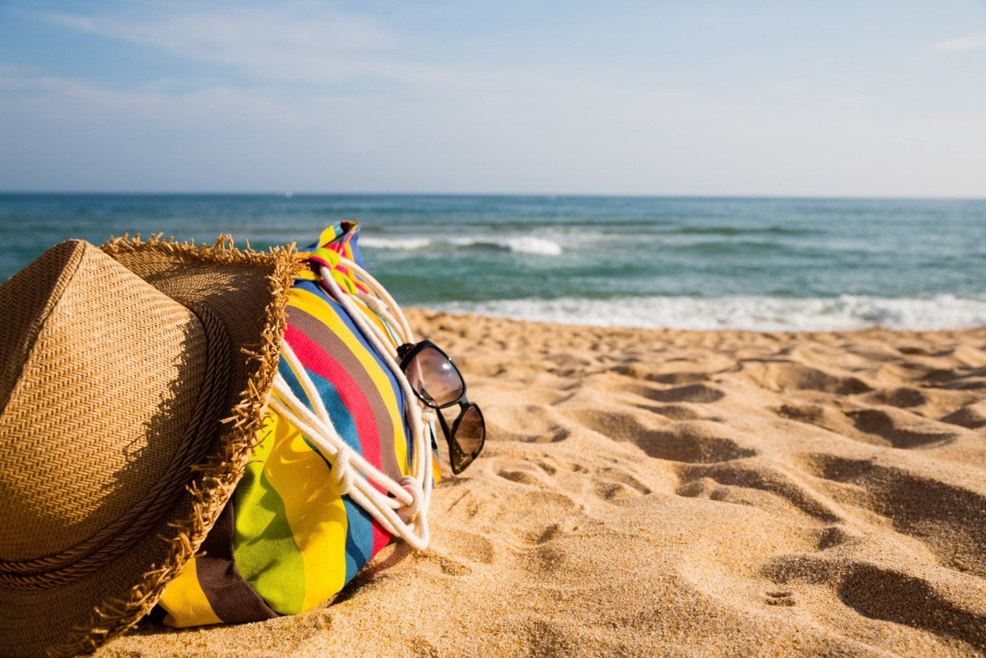 Beach scene with people enjoying the sun and sand, protected from flies
