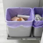 A brimming rubbish bin overflowing with household waste