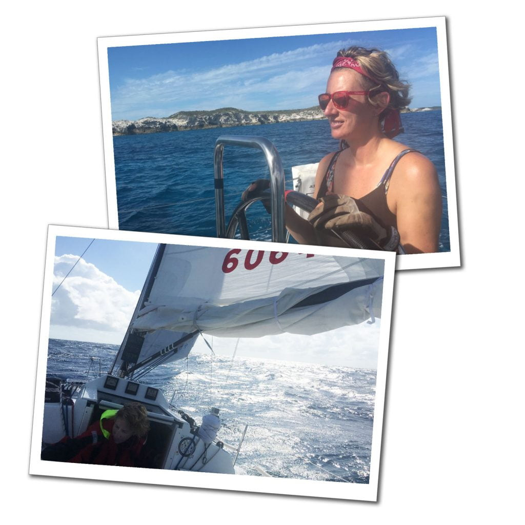 A blonde woman in red sunglasses standing at the wheel of a yacht as sails in deep blue caribbean sea