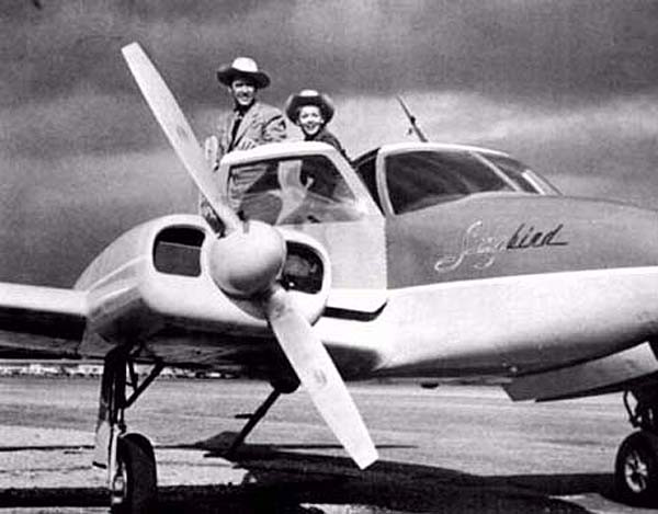 Sky King and Penny in front of their airplane