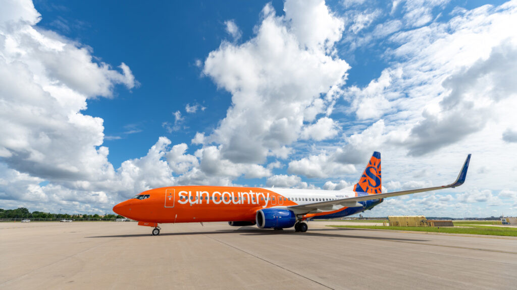 Sun Country Airlines Boeing 737-800 taking off, showcasing its livery and powerful engines.