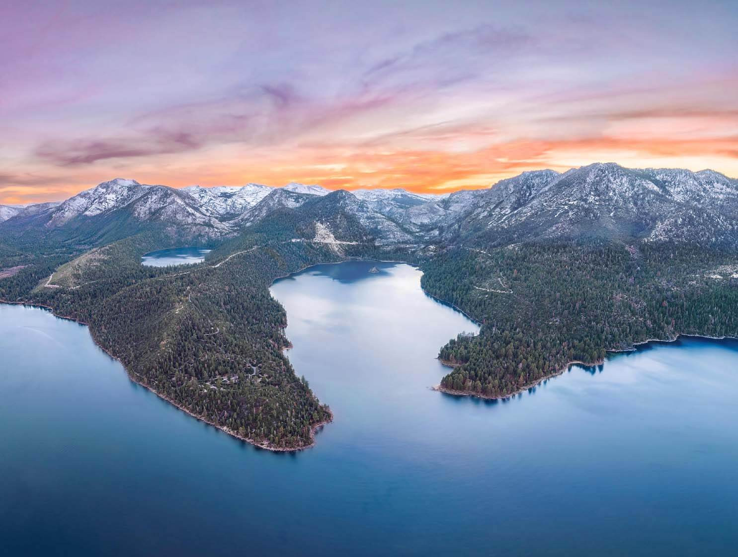 Sunset over Emerald Bay Lake Tahoe with vibrant orange and purple hues
