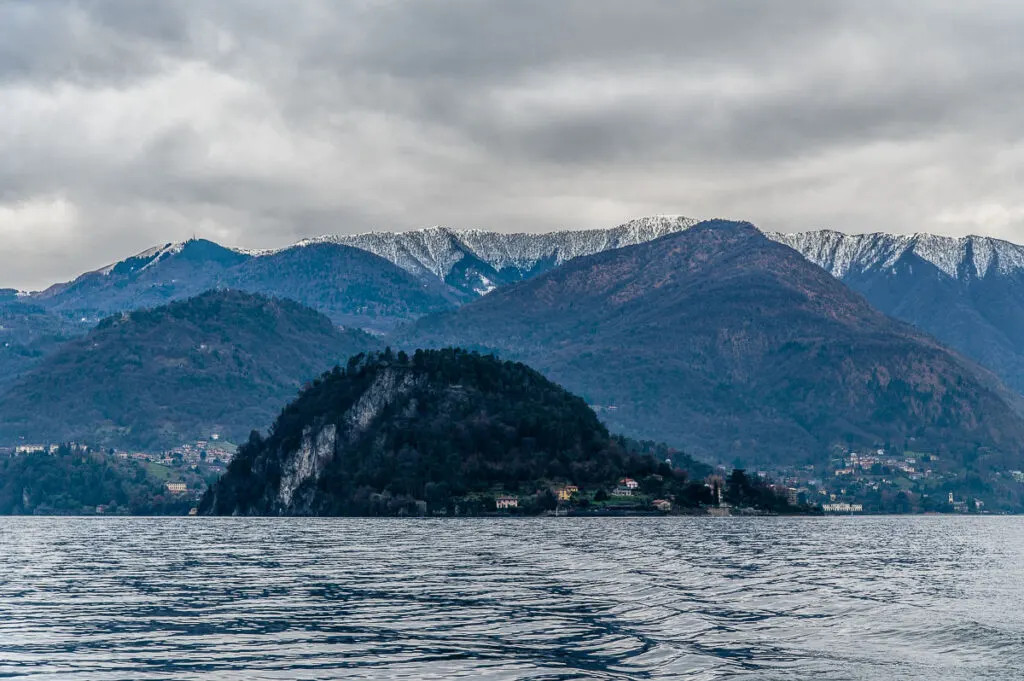 The Larian Triangle with snow-capped mountains seen from the ferry to Varenna - Lake Como, Italy - rossiwrites.com