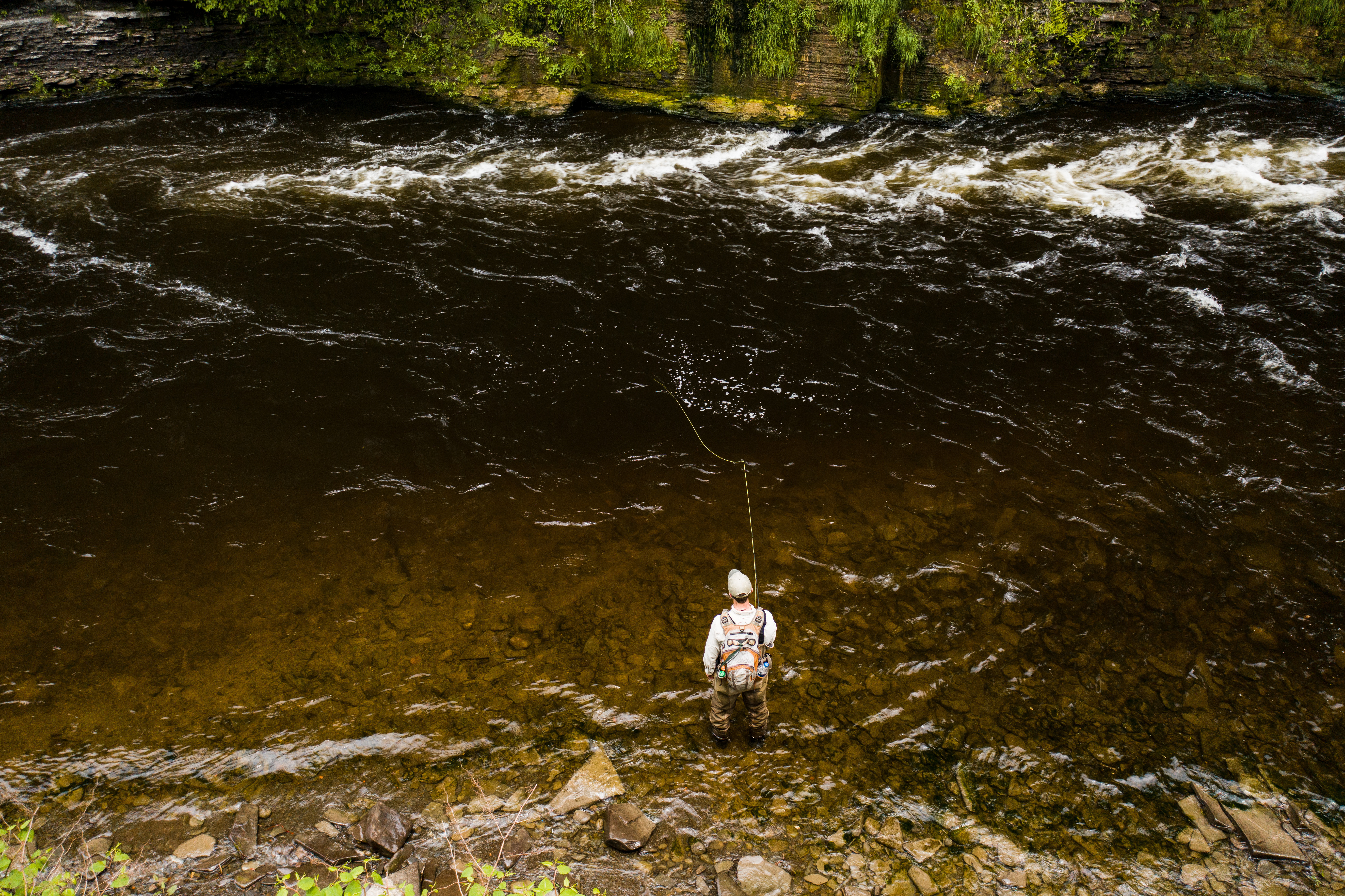 Angler with fish caught on a streamer fly