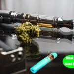A close-up shot of a disassembled weed pen, showcasing the battery, atomizer, heating chamber, and mouthpiece.