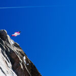 A wingsuit BASE jumper soars through the air, showcasing the skill and precision required for the sport