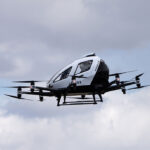 Flying car prototype taking off vertically, showcasing the future of urban air mobility