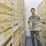 man holding specimen drawer