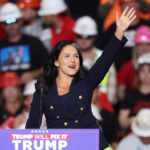 Tulsi Gabbard waves at a Donald Trump rally