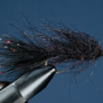 Fly tying vice holding a hook